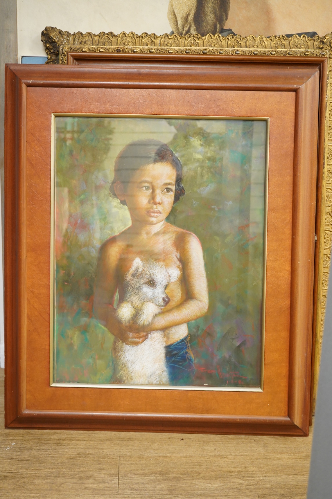 20th century, Portrait of a young Thai girl holding a puppy, indistinctly signed and dated 1981 together with a similar pastel of a young boy holding a dog, indistinctly signed and dated '82, largest 70 x 54cm